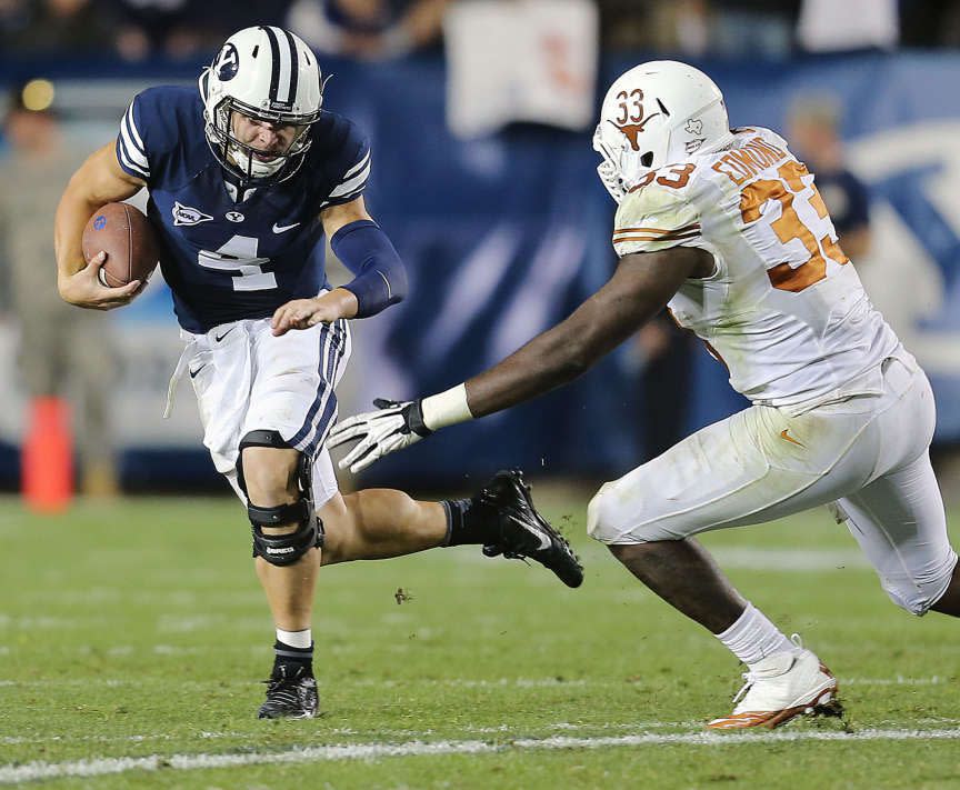 BYU quarterback Taysom Hill runs away from a Texas linebacker on Saturday, Sept. 7, 2013, at LaVell Edwards Stadium. Hill is an uncle through marriage to John Henry Daley and Michael Daley. | Scott G Winterton, Deseret News