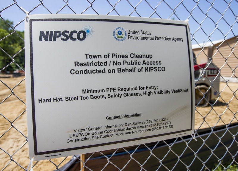 A sign notifies visitors of remediation taking place on behalf of NIPSCO at The Pines town park, on Delaware Street, where coal ash is being removed. Tribune Photo/ROBERT FRANKLIN