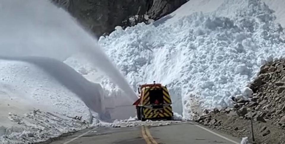 A Caltrans snowplow approaches a veritable wall of snow on Tioga Road, the road that crosses the Sierra Nevada range from Yosemite National Park to Lee Vining on U.S. Highway 395 near Mono Lake on the east slope of the mountains, in this Caltrans photo from late April 2023. A stubborn record snowpack as well as road damage from winter storms is also creating problems in Kings Canyon and Sequoia National Parks and the Sierra and Sequoia National Forests.