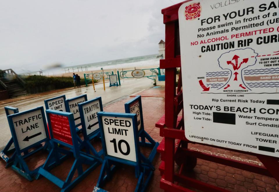 A few storm-watchers check out the scene on Wednesday at the Granada Boulevard beach ramp in Ormond Beach as Hurricane Ian's effects start to hit Volusia County.