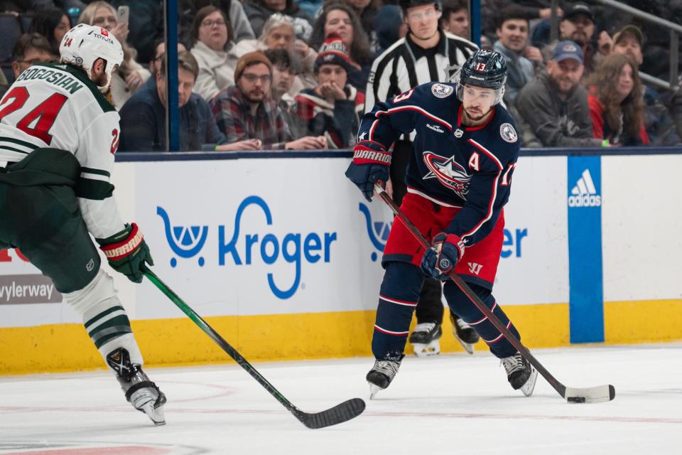 Jan 6, 2024; Columbus, Ohio, USA;
Columbus Blue Jackets left wing Johnny Gaudreau (13) looks for an open pass around Minnesota Wild defenseman Zach Bogosian (24) during the third period of their game on Saturday, Jan. 6, 2024 at Nationwide Arena.