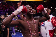 Yordenis Ugas, of Cuba, celebrates his unanimous decision win over Manny Pacquiao, of the Philippines, in a welterweight championship boxing match Saturday, Aug. 21, 2021, in Las Vegas. (AP Photo/John Locher)