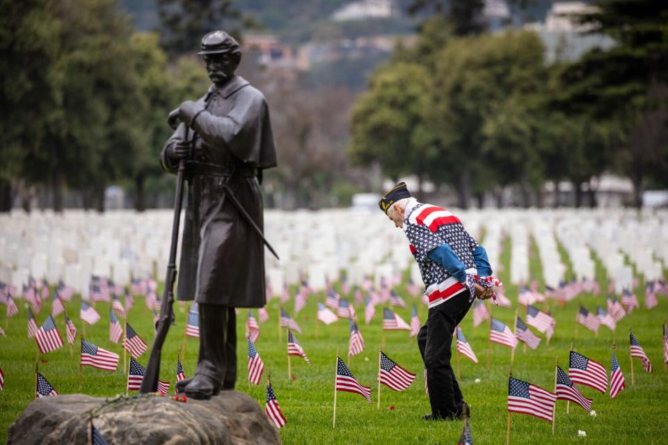 Jack Knight, 85, who served four years in the Army, walks through Los Angeles National Cemetery, in Los Angeles, CA.