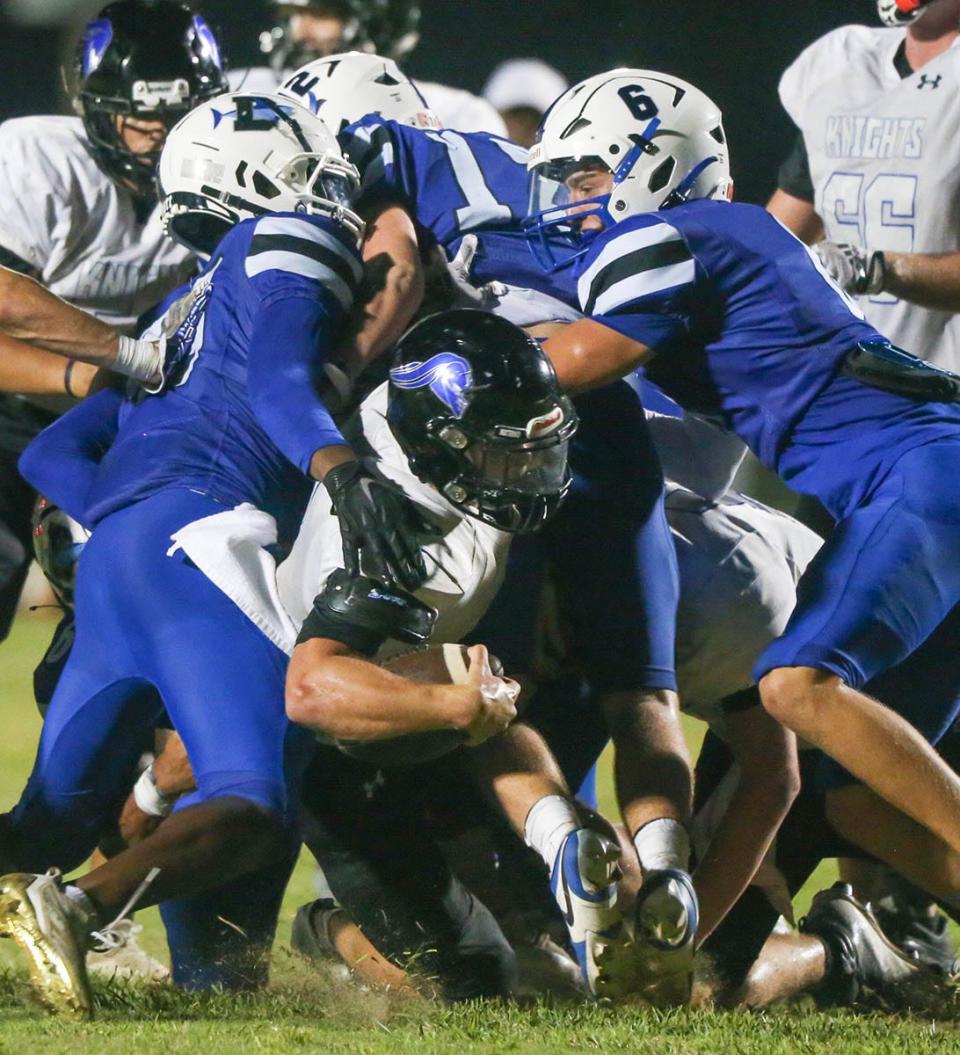 Sharks CB Tracen Trahan (6) helps stop Rocky Bayou RB Gideon Rossell near the goal line during the Destin-Rocky Bayou football game played at Destin.