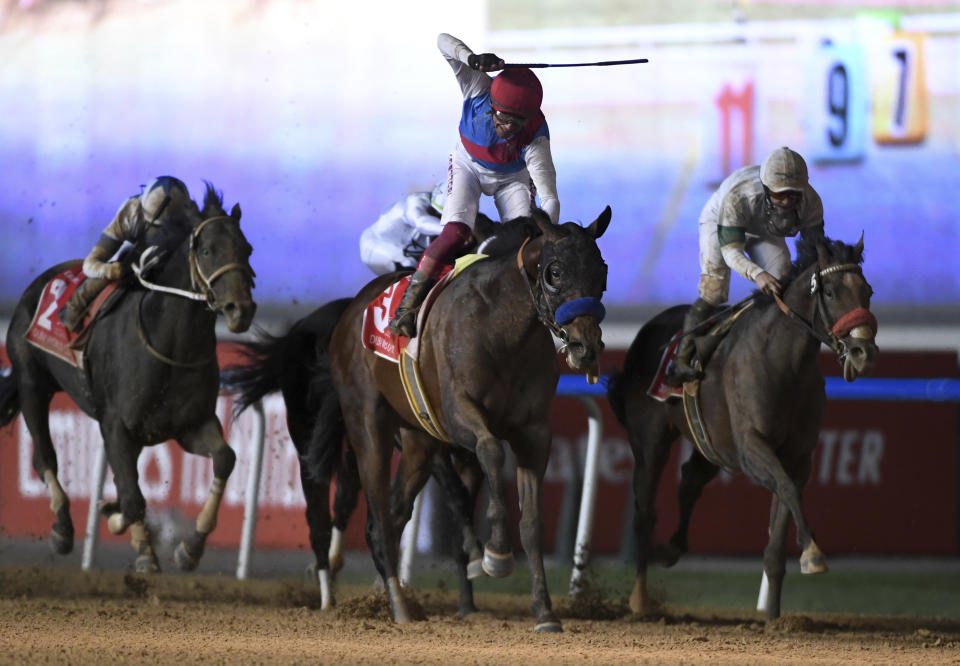 Country Grammer with jockey Frankie Dettori wins Group 1 Dubai World Cup over 2000m (10 furlongs) at Meydan Racecourse in Dubai, United Arab Emirates, Saturday, March 26, 2022. (AP Photo/Martin Dokoupil)