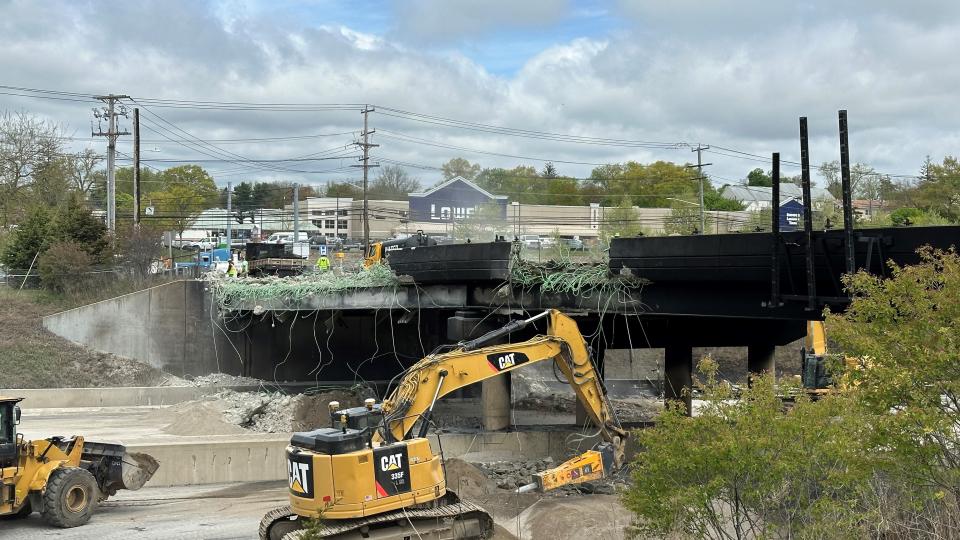 Crews with the Connecticut Department of Transportation work to remove debris on Friday, May 3 in the aftermath of a multi-vehicular crash on the I-95 that severely damaged an overpass.