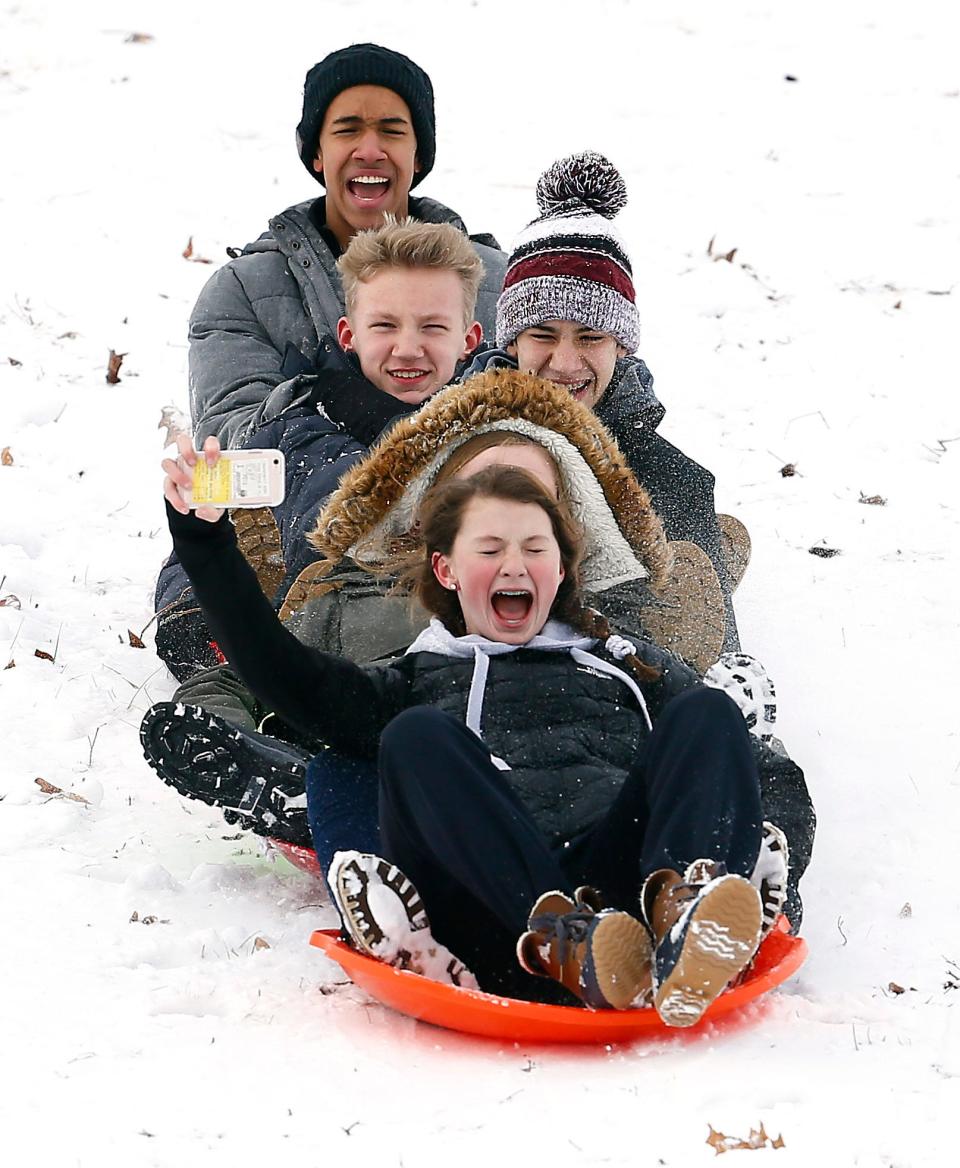 Five friends from Morristown fly down Villa Walsh Hill as children and their parents enjoy a day off from school sledding in Morristown after the area received about 4 inches of snow. January 17, 2018. Morristown, NJ.