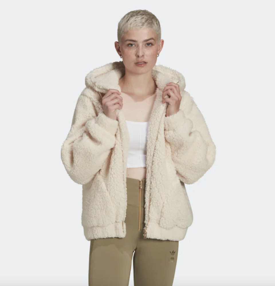 blonde model with short hair in green yoga pants and white Sherpa Jacket (Photo via Adidas)