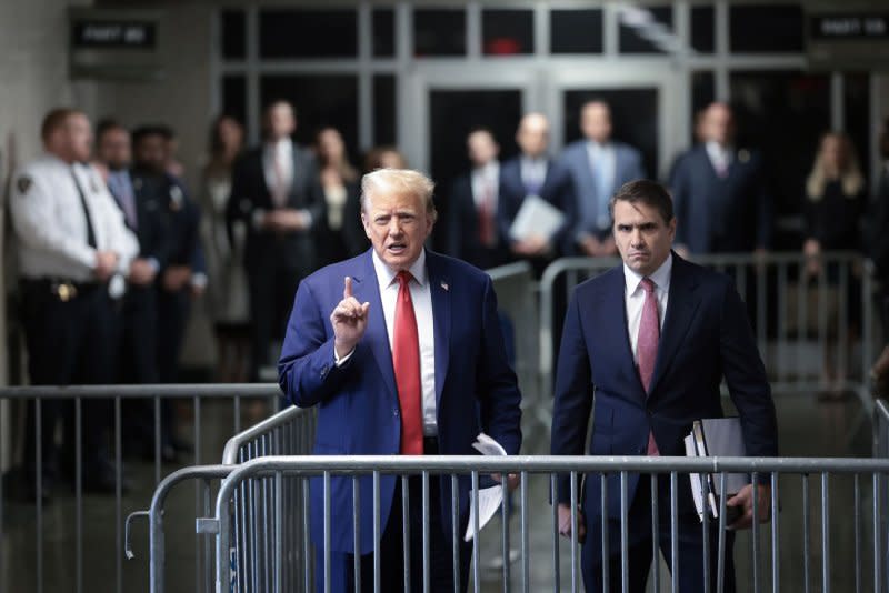 Former President Donald Trump speaks to reporters as he arrives for his trial at Manhattan criminal court in New York on Monday. Before entering, Trump had again called the judge "conflicted," a word he repeatedly uses to describe Merchan. Pool photo by Win McNamee/UPI