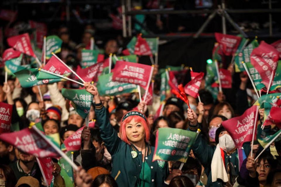 Supporters of Taiwan’s vice president and president-elect from the Democratic Progressive Party (DPP) Lai Ching-te (C) wait for him to speak at the party’s headquarters on 13 January 2024 in Taipei, Taiwan (Getty Images)