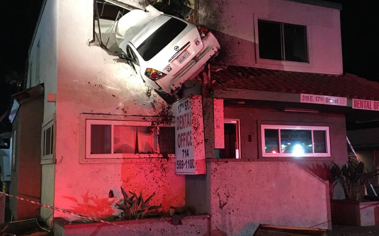 A Nissan crashed into the second floor of a building in Santa Ana early on Saturday - Cover Images