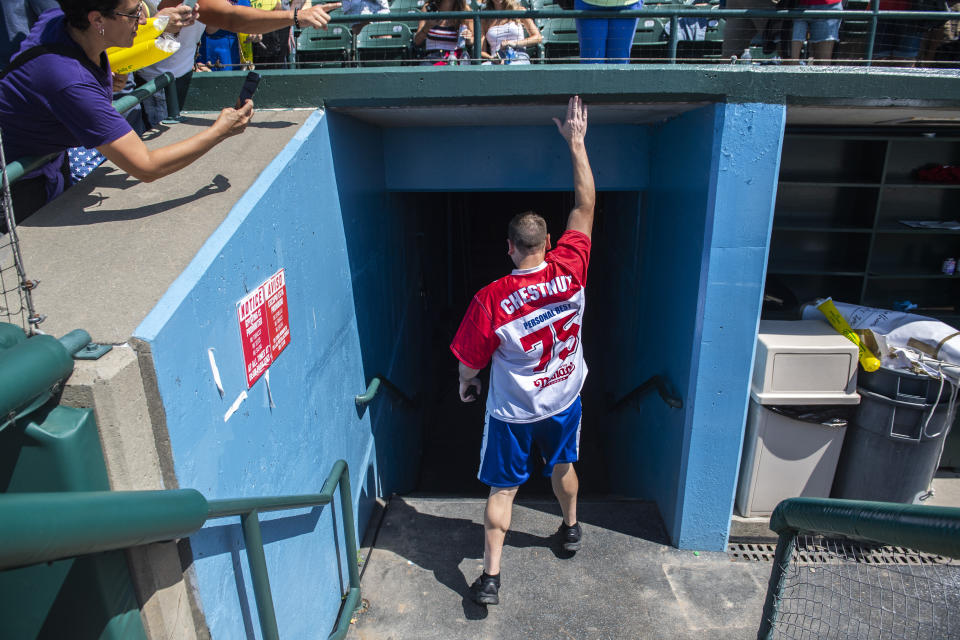 Joey Chestnut taps the stands for good luck before prepping inside at the Nathan's Famous Fourth of July International Hot Dog-Eating Contest in Coney Island's Maimonides Park on Sunday, July 4, 2021, in New York. (AP Photo/Brittainy Newman)