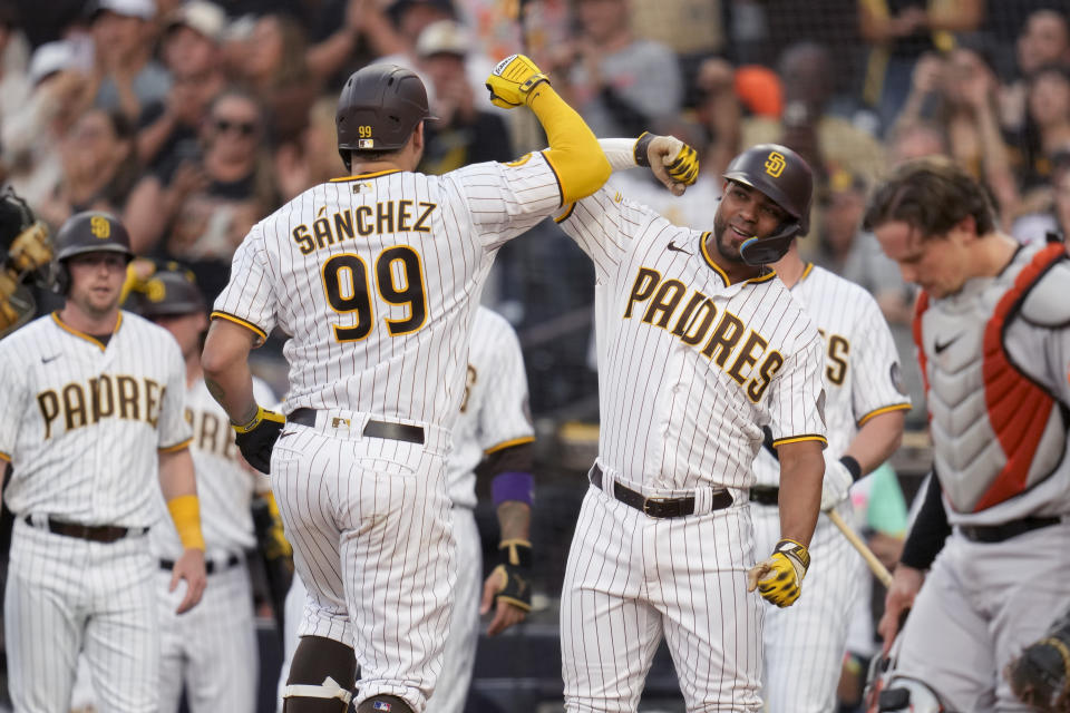 San Diego Padres' Gary Sanchez (99) is greeted by teammate Xander Bogaerts, right, after hitting a grand slam during the first inning of a baseball game against the Baltimore Orioles, Tuesday, Aug. 15, 2023, in San Diego. (AP Photo/Gregory Bull)