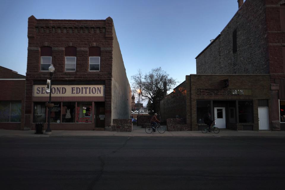 Two bikers pass through Pipestone, Minn., on Wednesday, May 3, 2023. (AP Photo/Jessie Wardarski)