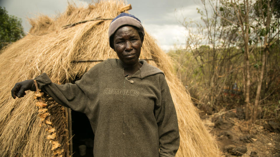 Hellen Ruttoh Tarko lived in a cave for more than a decade. Her new home is made of grass and sticks. (Photo: Zoe Flood)