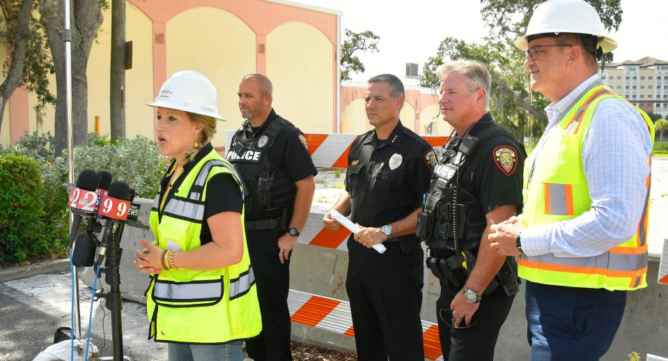 Flanked by Melbourne police, Brightline spokesperson Katie Mitzner addresses the media during a Tuesday rail safety press conference near the New Haven Avenue crossing in downtown Melbourne.