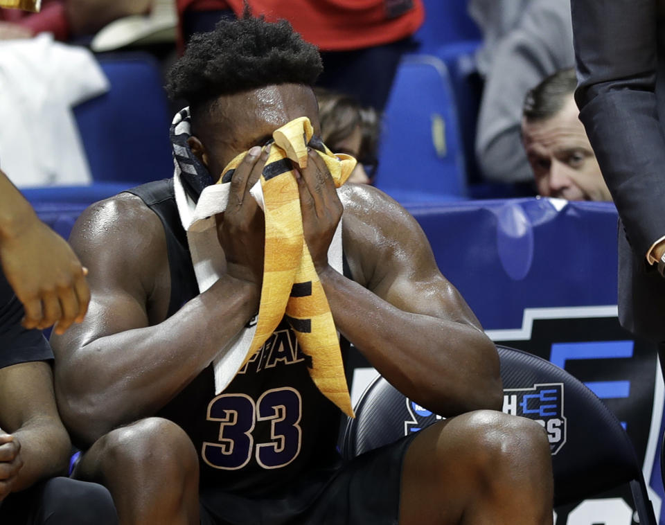 Buffalo's Nick Perkins wipes his face as he sits on the bench with less than a minute to go during the second half of a second round men's college basketball game against Texas Tech in the NCAA Tournament Sunday, March 24, 2019, in Tulsa, Okla. Texas Tech won 78-58. (AP Photo/Jeff Roberson)