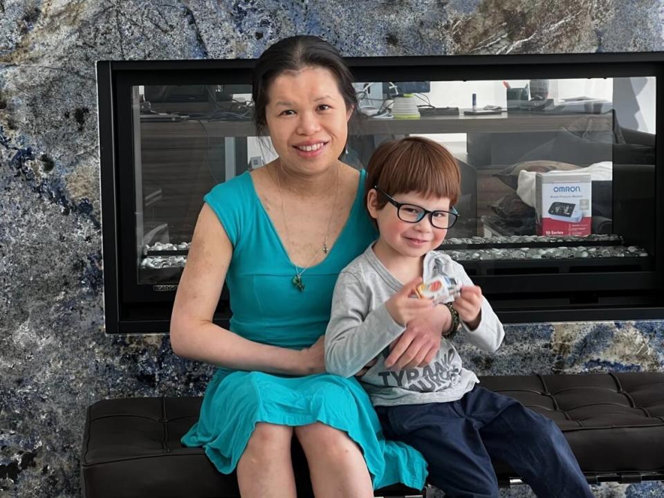 Cynthia Cheng Mintz, 42, pictured here with her son, has lived with neurofibromatosis since she was a child. She's now celebrating an $11-million donation to the University Health Network aimed at helping researchers understand the disorder better. (Adam Mintz - image credit)