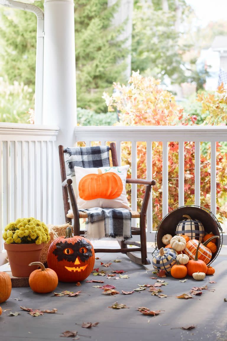 <p>Plaid is the signature pattern of fall, which means you can always incorporate it into your outdoor Halloween display. To make the plaid pumpkins seen here, choose two or three colors and add fine lines between the thick ones. </p>