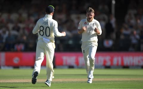 England bowler Sam Curran celebrates with Ollie Pope - Credit: &nbsp;Stu Forster/Getty Images