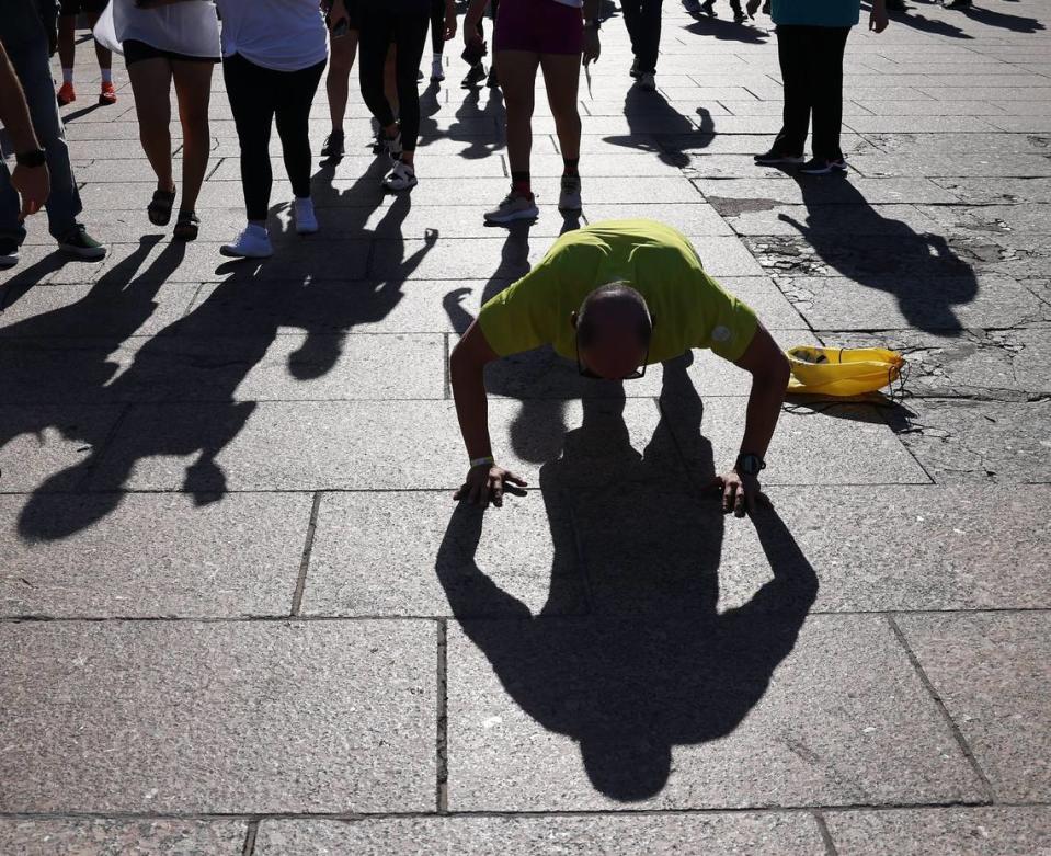 One runner does extra push-ups as he warms up before the start of the race.