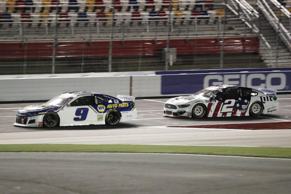 Chase Elliott (9) leads Brad Keselowski (2) during a NASCAR Cup Series auto race at Charlotte Motor Speedway Sunday, May 24, 2020, in Concord, N.C. (AP Photo/Gerry Broome)