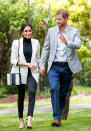 <p>On Sunday, Meghan went for a smart casual look in a white, pinstriped blazer and turtleneck top. Photo: Getty </p>