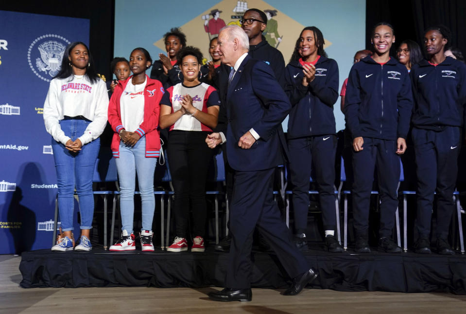 FILE - President Joe Biden jogs to the other side of the stage to talk with Delaware State University students after delivering a speech about student loan debt relief at the university on Friday, Oct. 21, 2022, in Dover, Del. (AP Photo/Evan Vucci, File)