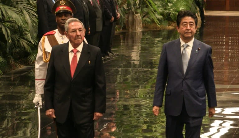 Japanese Prime Minister Shinzo Abe is received by Cuban President Raul Castro at the Palace of the Revolution in Havana, on September 22, 2016