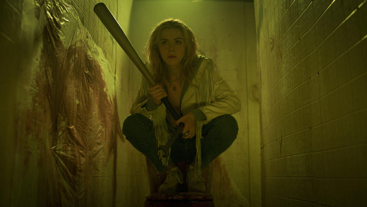  Jamie Hughes hides in a bathroom stall in Prime Video horror movie Totally Killer. 