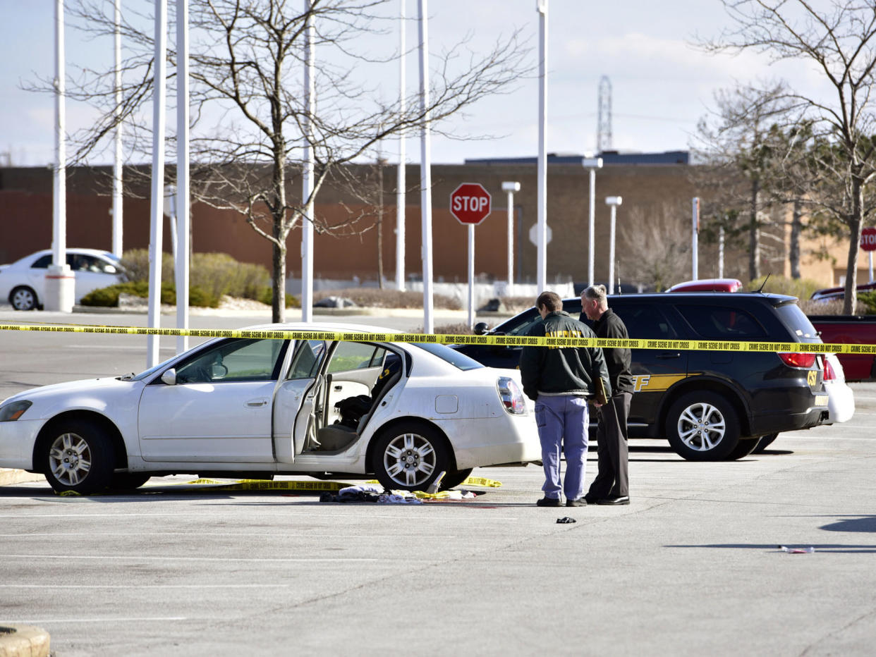 Police at the scene where a 3-year-old girl accidentally shot and wounded her pregnant mother in a car parked outside a northwestern Indiana shop: Rob Earnshaw/The Times via AP