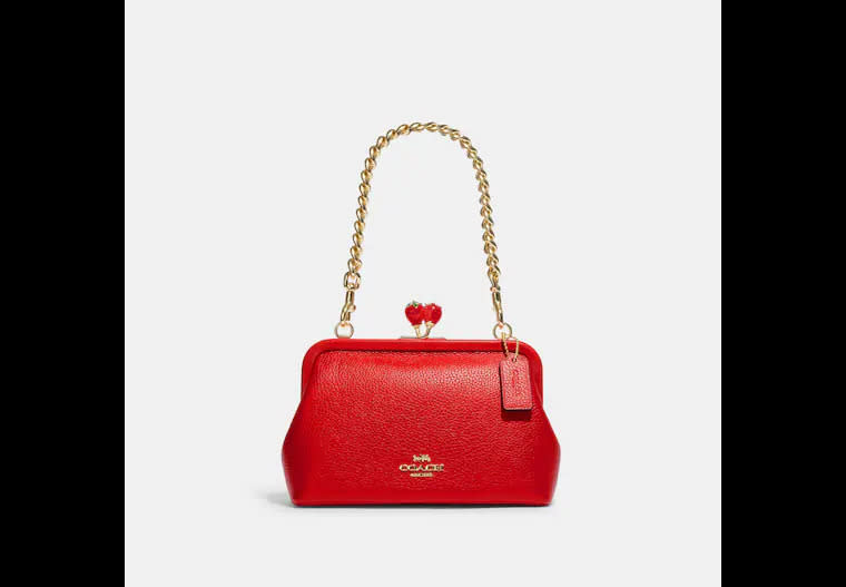 Nora Kisslock Crossbody With Strawberry. Image via Coach Outlet.