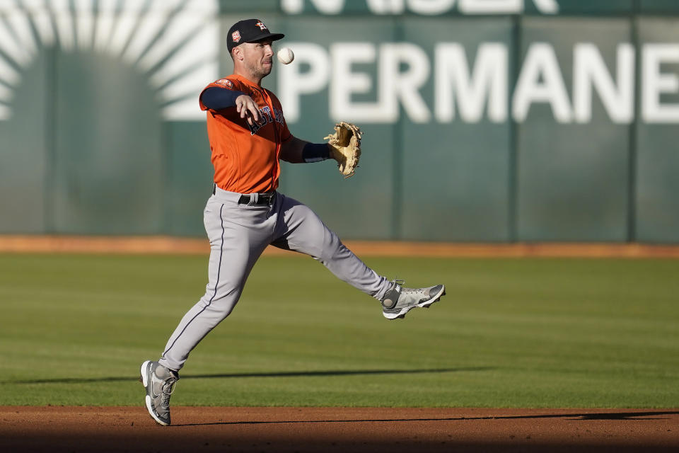 Houston Astros third baseman Alex Bregman throws out Oakland Athletics' Vimael Machin at first base during the first inning of a baseball game in Oakland, Calif., Monday, July 25, 2022. (AP Photo/Jeff Chiu)