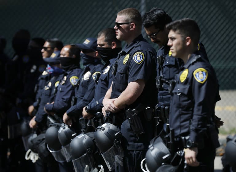 San Diego Police officers stand near police headquarters as a Black Lives Matter protesters gather in the area on June 14, 2020.