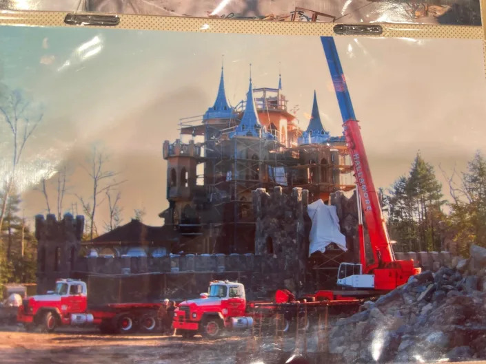 Construction machinery surrounds the castle.