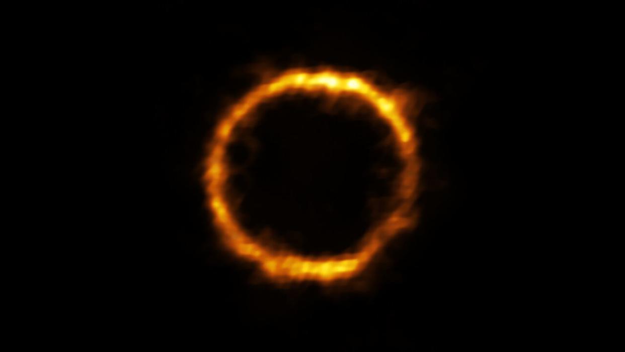  A gravitationally lensed view of a ring-shaped slice of the galaxy SPT0418-47, as seen by the ALMA array in Chile. Recent observations by NASA's James Webb Space Telescope reveal that the galaxy has a satellite that's rich in star formation. 