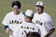 Japan's Roki Sasaki, left, and Shohei Ohtani, right, share a light moment during their team's practice at a stadium in Nagoya, central Japan, on March 3, 2023. All eyes will be on Japanese baseball pitcher Sasaki at the World Baseball Classic. He is regarded as the next big thing in baseball out of Japan. (Kyodo News via AP)