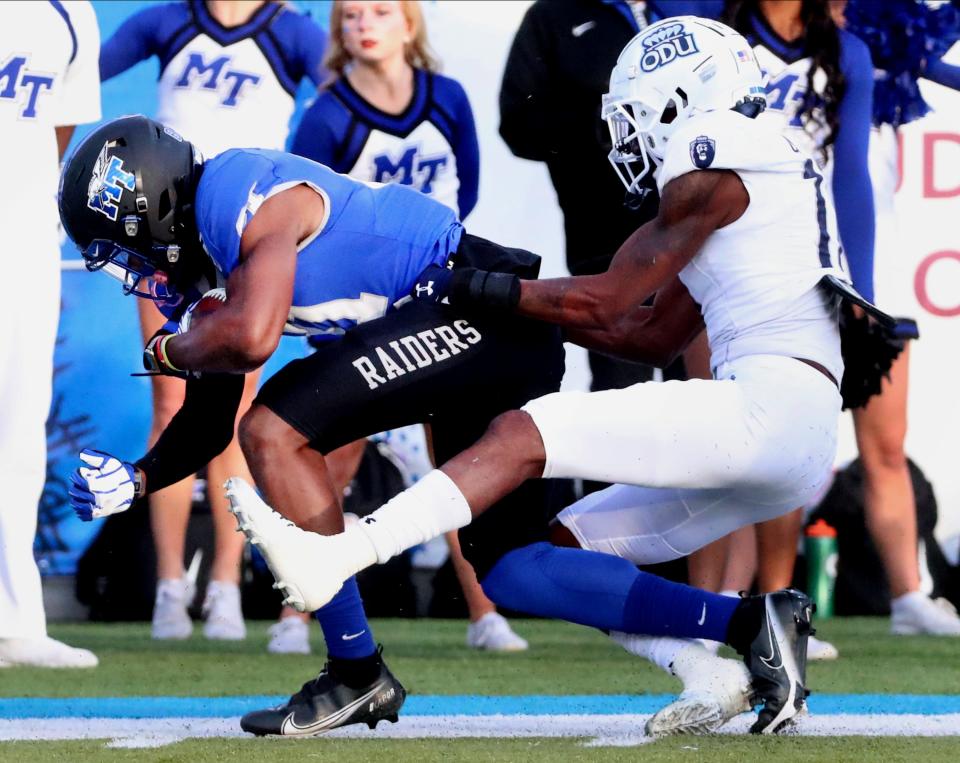 MTSU wide receiver CJ Windham (81) makes a catch and runs the bsll s Old Dominion cornerback Damion Charity (17) stops him on Saturday, Nov. 20, 2021.