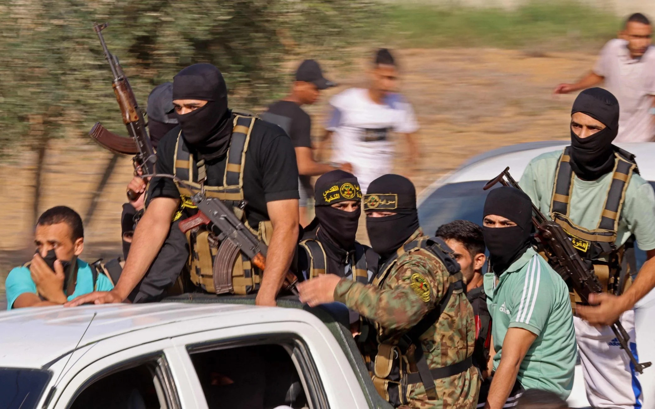 Palestinian gunmen move towards the border fence with Israel from Khan Yunis in the southern Gaza Strip