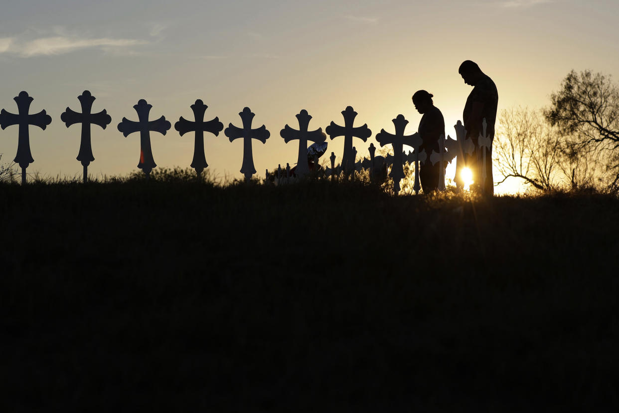 Kenneth and Irene Hernandez pay their respects as they visit a makeshift memorial with crosses placed near the scene of a shooting at the First Baptist Church of Sutherland Springs, Monday, Nov. 6, 2017, in Sutherland Springs, Texas. A man opened fire inside the church in the small South Texas community on Sunday, killing and wounding many. (AP Photo/Eric Gay) (Eric Gay / AP file)