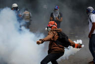 <p>Opposition supporters clash with security forces during protests against President Nicolas Maduro in Caracas, Venezuela, May 4, 2017. (Carlos Garcia Rawlins/Reuters) </p>