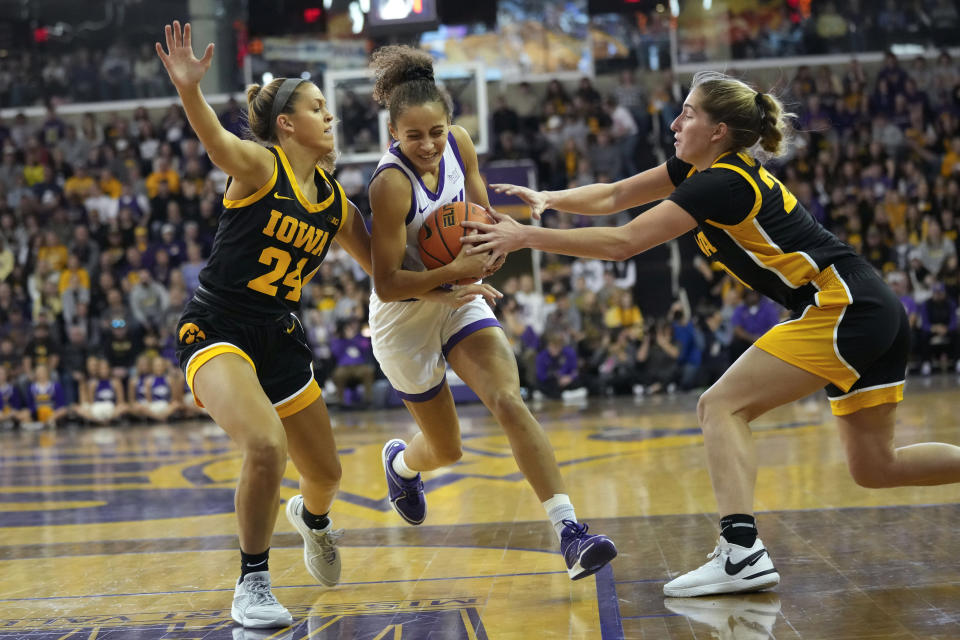 Northern Iowa guard Taryn Wharton, center, drives between Iowa guard Gabbie Marshall (24) and guard Kate Martin, right,during the first half of an NCAA college basketball game, Sunday, Nov. 12, 2023, in Cedar Falls, Iowa. (AP Photo/Charlie Neibergall)