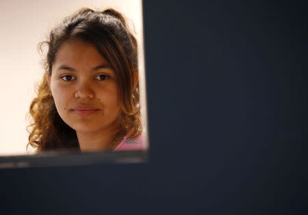 Honduran immigrant teen identifying herself as Suyen G. poses during an interview at the Ayuda office in Falls Church, Virginia May 19, 2014.REUTERS/Kevin Lamarque