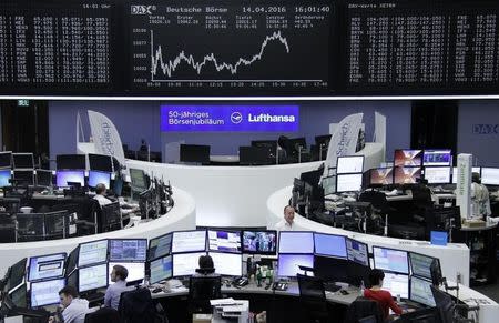 Traders work at their desks in front of the German share price index, DAX board, at the stock exchange in Frankfurt, Germany, April 14, 2016. REUTERS/Staff/Remote -