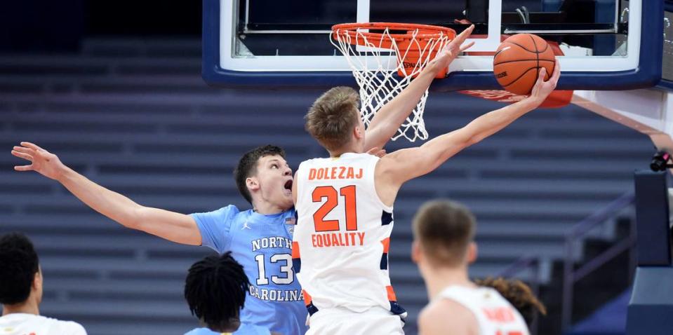 Syracuse Orange forward Marek Dolezaj (21) lays in a shot past North Carolina Tar Heels forward Walker Kessler (13) in a game between Syracuse and North Carolina at the Carrier Dome in Syracuse N.Y. March 1, 2021.