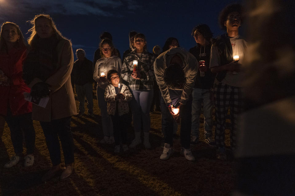 Community members gather for a candlelight vigil at Chesapeake City Park in Chesapeake, Va., Monday, Nov. 28, 2022, for the six people killed at a Walmart in Chesapeake, Va., when a manager opened fire with a handgun before an employee meeting last week. (AP Photo/Carolyn Kaster)