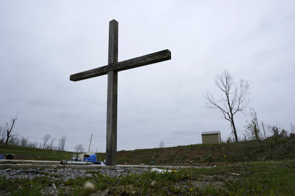 CORRECTS STATE TO KENTUCKY INSTEAD OF TENNESSEE - A makeshift cross stands on the foundation of a church destroyed in a Dec. 10 tornado on April 21, 2022, in Dawson Springs, Ky. Four months after a massive tornado tore through the state, hundreds of Kentuckians are arduously reconstructing their pre-storm existence. (AP Photo/Mark Humphrey)