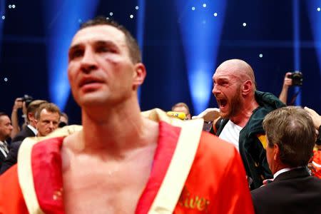 Tyson Fury celebrates after being declared the winner of the fight as Wladimir Klitschko looks dejected Reuters / Kai Pfaffenbach Livepic