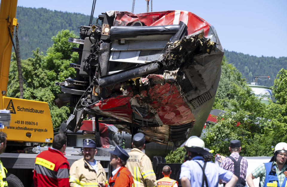 A carriage is being lifted on the site of a train crash in Burgrain, near Garmisch-Partenkirchen, Germany, Saturday, June 4, 2022. Authorities say a train accident in the Alps in southern Germany on Friday left at least four people dead and many more injured. Police said the regional train headed for Munich appears to have derailed shortly after noon in Burgrain — just outside the resort town of Garmisch-Partenkirchen, from where it had set off. Three of the double-deck carriages overturned at least partly, and people were pulled out of the windows to safety. (Sven Hoppe/dpa via AP)