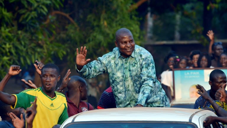 Central African Republic presidential candidate Faustin Archange Touadera waving to supporters during a presidential campaign tour in Bangui on December 28, 2015